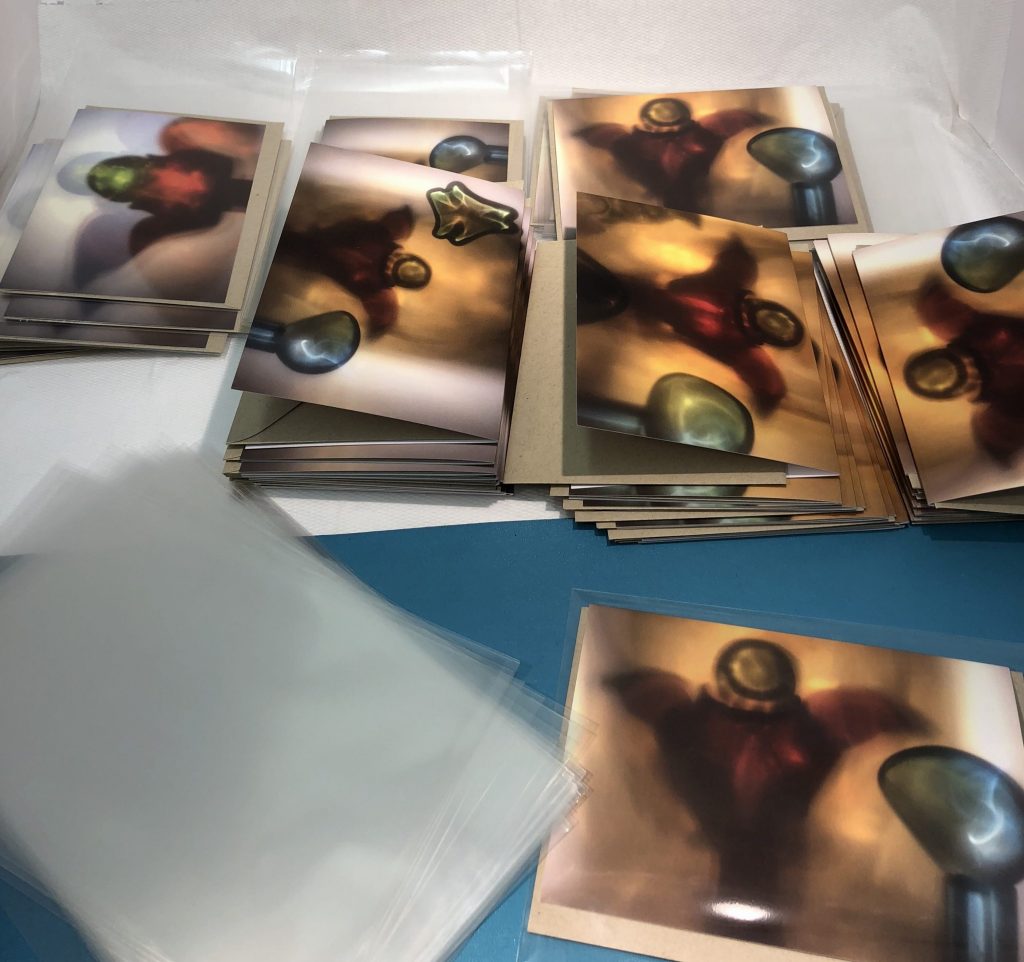 Greetings cards being put into plastic sleeves
