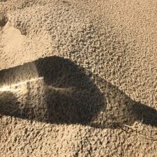 Light through bottle on the sand